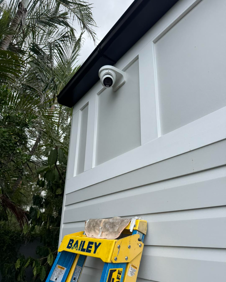 Turret camera on exterior weatherboard wall