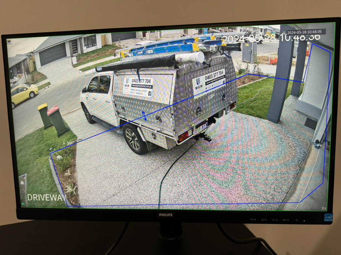 CCTV driveway view with MGM Security work vehicle